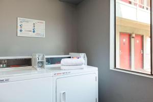 a washing machine with a towel on top of it at America's Best Value Inn & Suites Bakersfield Central in Bakersfield