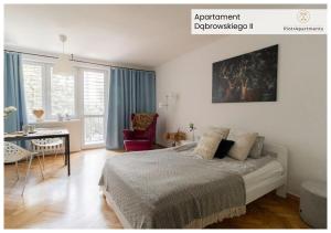 a bedroom with a bed and a desk in it at PiotrApartments - Big City Life Apartments in Central Warszawa in Warsaw