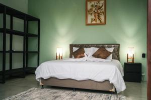a bedroom with a large bed with white sheets at Jimbaran Beach Bliss Villa, Bali in Ngurah Rai International Airport +26 photos