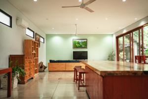 a living room with a bar and a tv at Jimbaran Beach Bliss Villa, Bali in Ngurah Rai International Airport