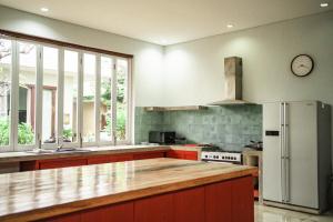 a kitchen with a counter top and a refrigerator at Jimbaran Beach Bliss Villa, Bali in Ngurah Rai International Airport