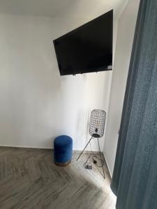 a room with a flat screen tv on a wall at Loft ËNXË Boutique Habitación Gray in Cuetzalán del Progreso