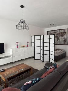 a living room with a couch and a table at Beautiful apartment in the city center,with full amenities in Poprad