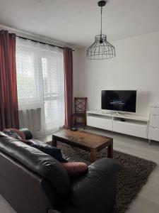a living room with a leather couch and a coffee table at Beautiful apartment in the city center,with full amenities in Poprad +14 photos