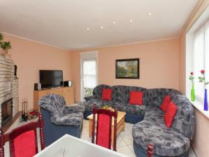 a living room with a couch and two chairs at Ferienhaus mit Wellnessbereich in Elend in Elend