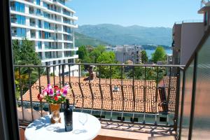 a balcony with a table with a vase of flowers at Apartments Luka in Budva