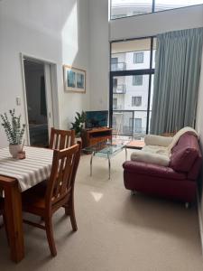 a living room with a couch and a table at City CBD Retreat in Perth