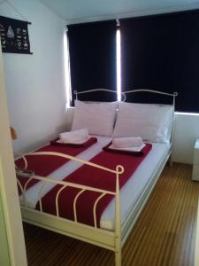 a bed with two towels on it in a room at Apartment Plaza in Hvar