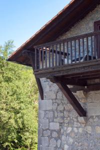 
a cat sitting on top of a wooden ledge at Hotel Antsotegi in Etxebarria
