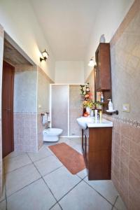 a bathroom with a sink and a toilet at Masseria Cinti in Bagnolo del Salento