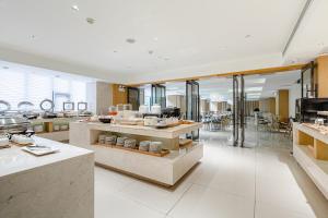 a large kitchen with a counter with dishes at JI Hotel Beijing Yizhuang Economic Development Zone in Beijing