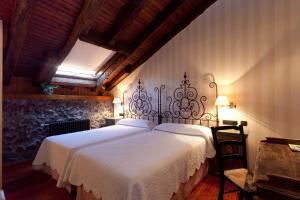 
a hotel room with a large bed and a large window at Hotel Antsotegi in Etxebarria
