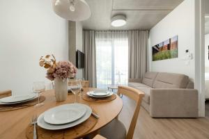 a living room with a table and a couch at Luxury Apartments with Parking and Air Conditioning near Wrocław City Center by Renters Prestige in Wrocław