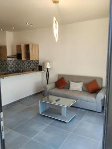 a living room with a couch and a coffee table at One B2b Apartment w balcony with Jacuzzi at Makadi Heights in Hurghada