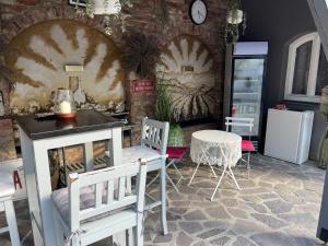 a room with chairs and a table and a clock at Penzion ve dvoře in Mikulov