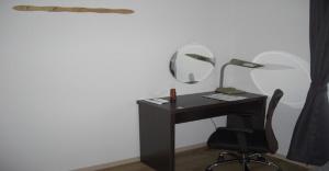 a black desk with a mirror and a chair at 2-10-15 Imagawa - Apartment / Vacation STAY 7905 in Tokyo