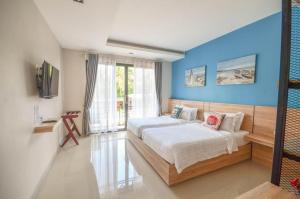 a bedroom with a bed and a blue wall at SEESEA RESORT in Amphoe Langu +159 photos