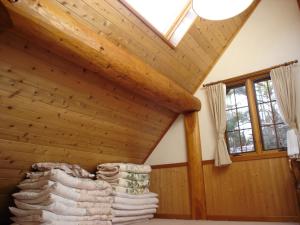 a room with a wooden ceiling with a skylight at Cottage All Resort Service / Vacation STAY 8416 in Inawashiro