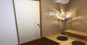 a room with a door and a bench and a table at 3-25-2 Higashiogu - Apartment / Vacation STAY 8348 in Tokyo