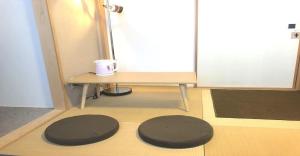 two mats on the floor of a room with a door at 3-25-2 Higashiogu - Apartment / Vacation STAY 8348 in Tokyo