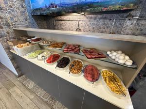a shelf filled with lots of different types of food at Hotel Baykal in Istanbul