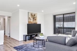a living room with a couch and a tv at East Haven Creek 