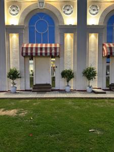 Un edificio con puertas azules y plantas en un patio. en Torque Stays, en Noida
