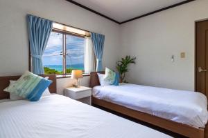 Giường trong phòng chung tại SEA SIDE HOUSE Ogimi / Vacation STAY 9241