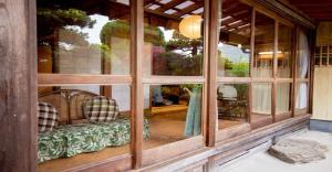 a large window of a house with a bench in it at Kumano - House / Vacation STAY 9764 in Kumano