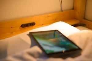 a cell phone sitting on top of a bed at Guest house Kintoto - Vacation STAY 9776 in Kanazawa