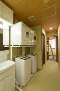 a kitchen with a stove and a microwave at Guest house Kintoto - Vacation STAY 9776 in Kanazawa