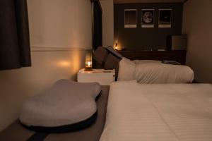 a hotel room with two beds and a chair at HOTEL SPICE - Vacation STAY 34504v in Ishigaki Island