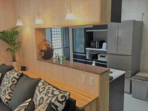 a living room with a couch and a kitchen at Nago - House / Vacation STAY 76289 in Nago
