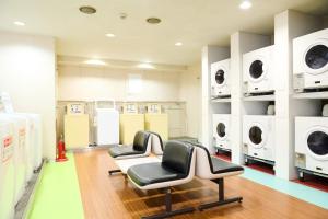 a laundry room with two chairs and washing machines at Sapporo - Apartment - Vacation STAY 43085v in Sapporo