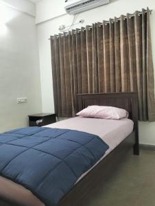 Ένα ή περισσότερα κρεβάτια σε δωμάτιο στο BG Greens Service Apartments