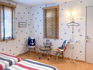 a childrens room with two beds and two chairs at Pension Marinetown Aratta Vacation STAY 13299 in Gaja