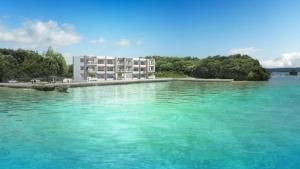 a building in the middle of a large body of water at Lala court seaside Yagaji / Vacation STAY 3226 in Nago