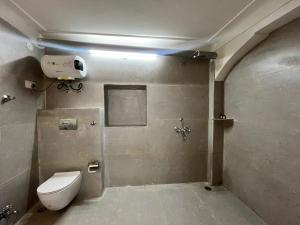 a bathroom with a white toilet in a room at Khush Haveli in Jaipur