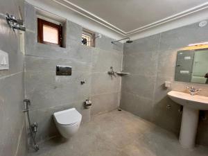 a bathroom with a toilet and a sink at Khush Haveli in Jaipur +13 photos