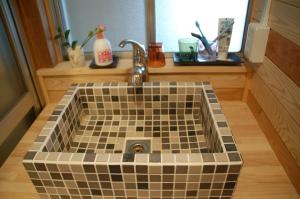 a bathroom with a sink with a tiled counter at Tabinoya - Vacation STAY 69884v in Kakegawa +14 photos