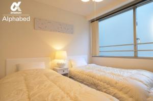 Postel nebo postele na pokoji v ubytování Alphabed TakamatsuHyogomachi 502 / Vacation STAY 21893