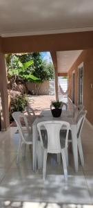 a white table and chairs on a patio at Recanto das Pedras in Andaraí