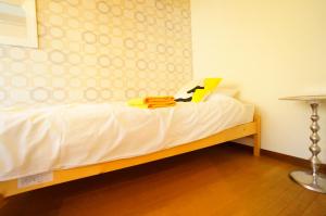 a bedroom with a bed with a book on it at Takayama - Apartment / Vacation STAY 34381 in Takayama