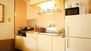 a kitchen with a sink and a refrigerator at Takayama - Apartment / Vacation STAY 34379 in Takayama