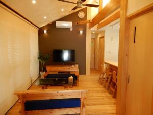 a living room with a tv and a table and a table sidx sidx at Uruma - House - Vacation STAY 16594 in Uruma