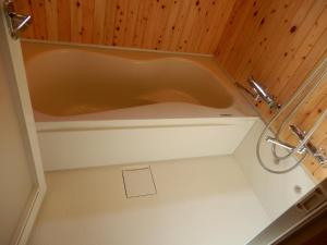 a bath tub in a bathroom with a wooden ceiling at Uruma - House - Vacation STAY 16594 in Uruma +23 photos