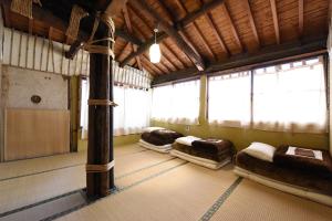 a room with three beds in it with windows at Tsukubo-gun - House / Vacation STAY 34603 in Hayashima
