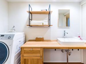 a laundry room with a sink and a washing machine at Rakuten STAY HOUSE x WILL STYLE Takasaki 105 in Takasaki