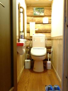 a bathroom with a toilet and a wooden wall at Kameda-gun - Cottage / Vacation STAY 34923 in Nanae +33 photos