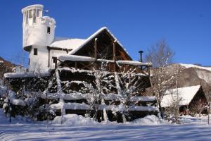 a building covered in snow with a lighthouse at Kameda-gun - Cottage / Vacation STAY 34923 in Nanae